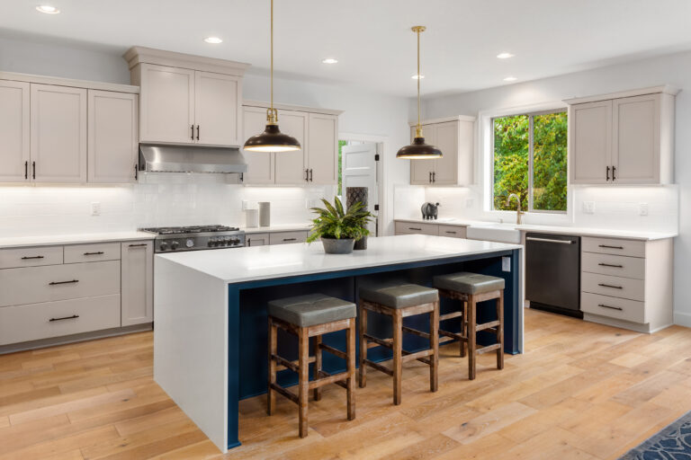 Beautiful kitchen in new luxury home with waterfall island, quar